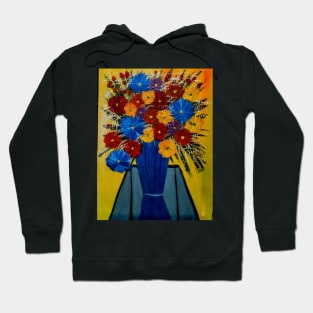 mixed flowers in a blue vase on a glass table Hoodie